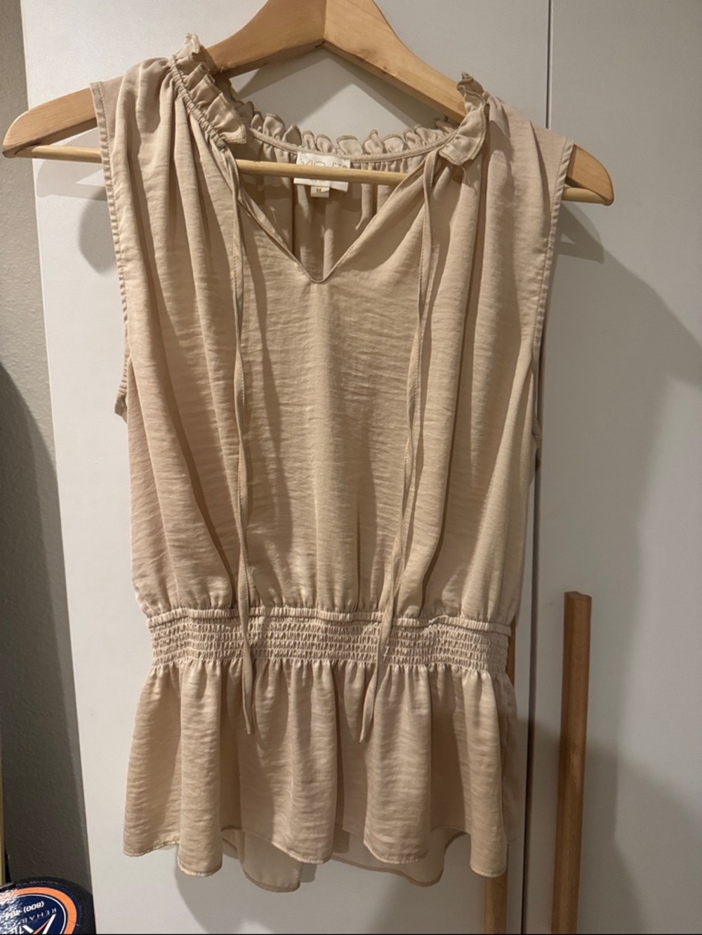 Sleeveless V-Neck Peplum Blouse in Beige